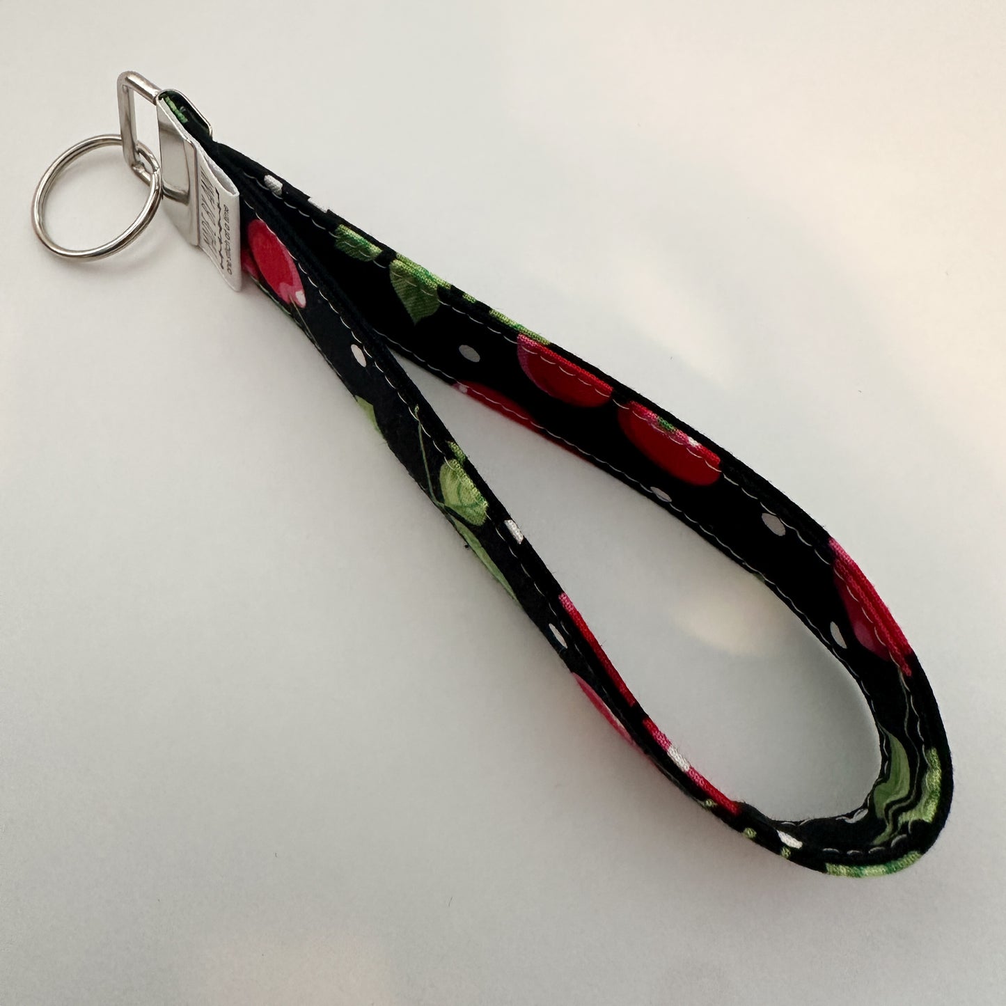 Keychain with cherry design on a black background