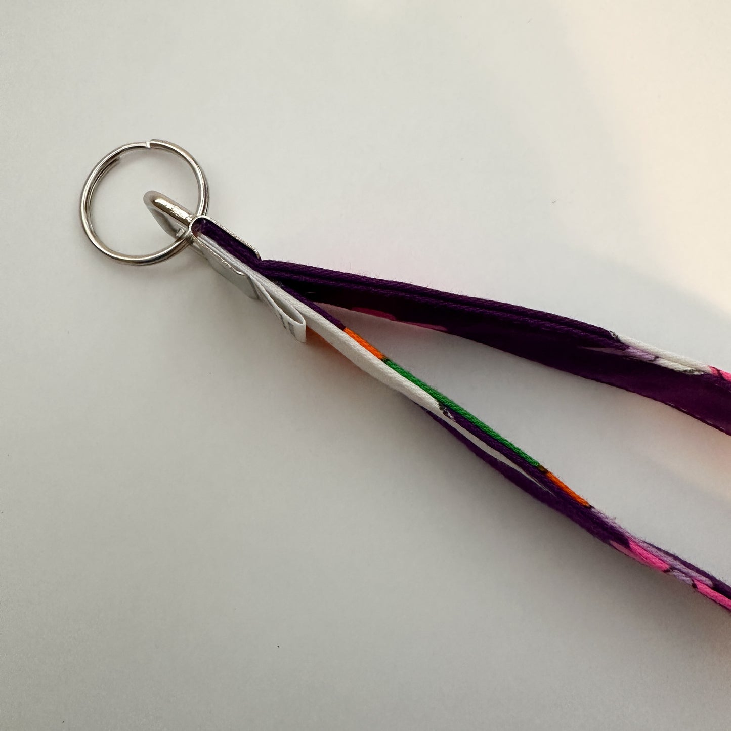 Keychain with pink floral design on a purple strap