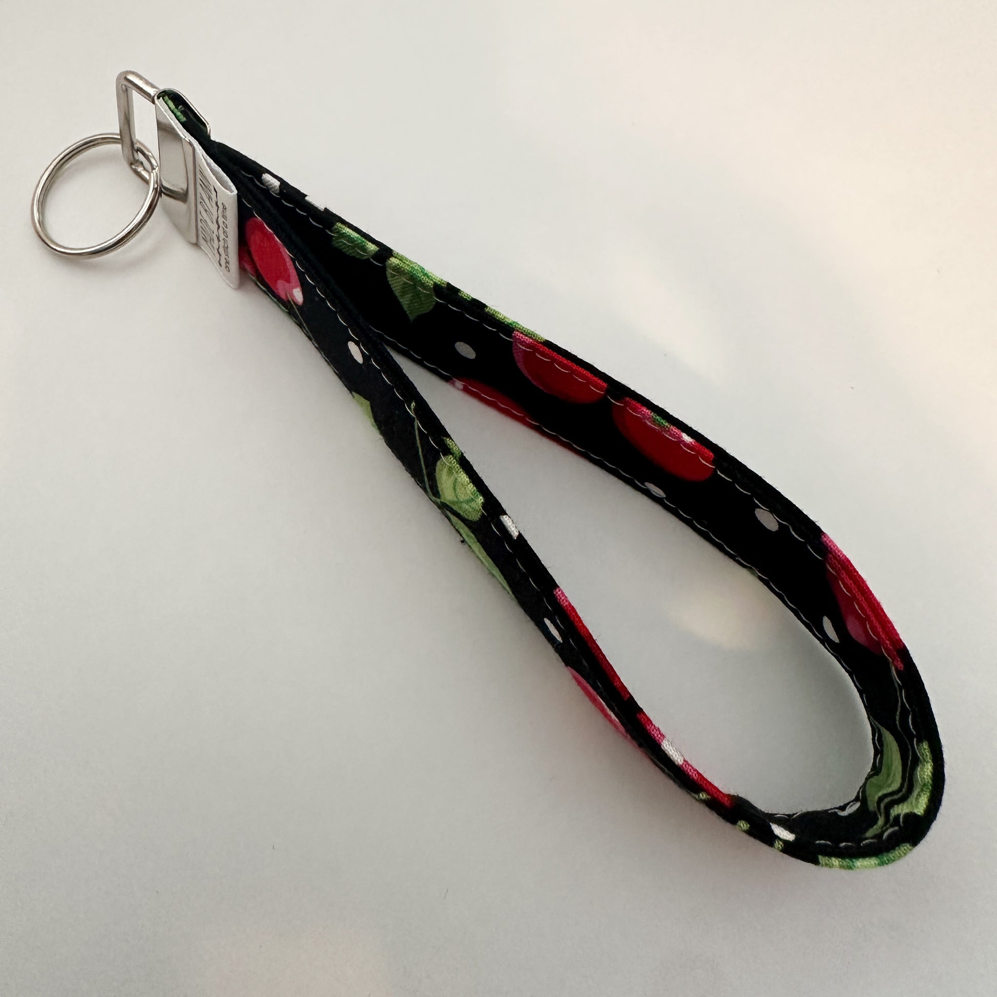 Keychain with cherry design on a black background