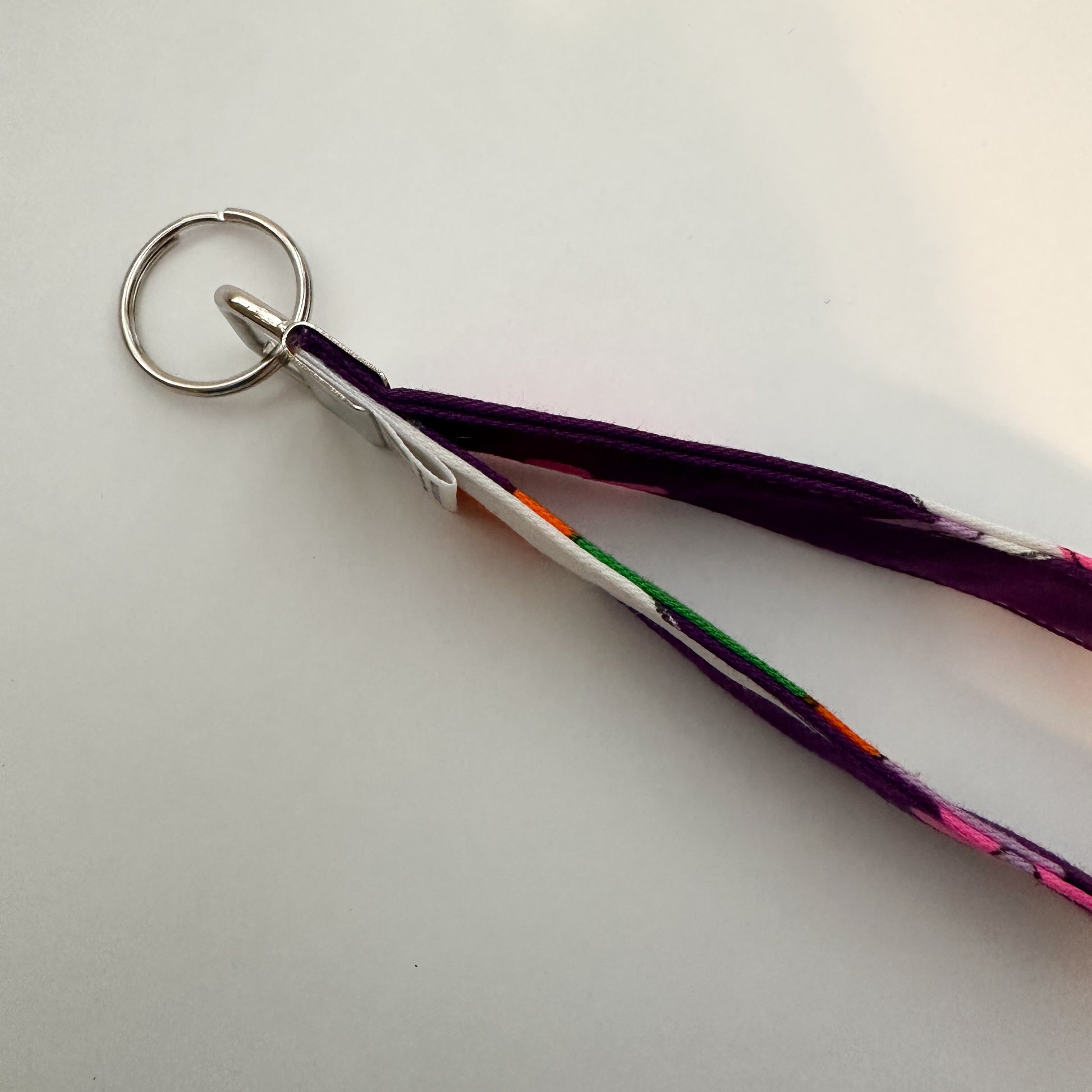 Keychain with pink floral design on a purple strap